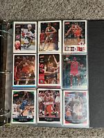 Binder page showing nine basketball cards featuring players in game and posed shots, including rookie cards and cards with team logos.