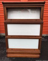 Front view of three-tier barrister bookcase showing top glass panel and lower panels