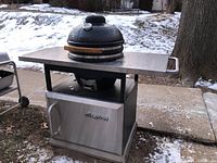Full front view showing ceramic dome on stainless cart with cabinet door and side shelf