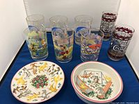 Six McDonalds Disney collectible glasses, two Hardees Coca-Cola glasses, Tiffany & Co. child's plate and bowl shown on table.
