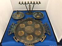 Display of the full set: menorah, serving tray, candy dish, decorative bowl, and Passover seder plate.