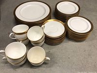 Full set overview showing stacks of plates arranged by size and cups beside them.