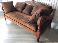 Front and side view showing overall condition, cushions and carved back