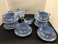 All pieces displayed: teapot with lid, sugar bowl with lid, creamer, six cups and six saucers