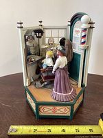 Front and side view showing detailed figures and barber shop interior with boy in chair, barber, and woman observer