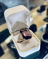 Large rectangular purple stone ring in 8K gold-filled setting shown in a white box.