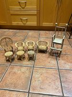 Full set arranged showing various wicker chairs, loveseat, stools, and wooden high chair on tiled floor.