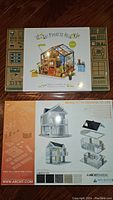 Two boxes visible: the DIY Miniature House kit with a glasshouse miniature on the box, and the ARCKIT Architectural Model kit with images of a modern house design and individual pieces shown on the box.