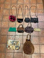 Full view of all 10 purses displayed on tiled floor