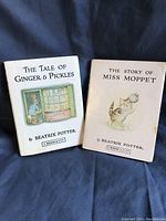 Two Beatrix Potter books with original dust jackets: The Story of Miss Moppet and The Tale of Ginger & Pickles.