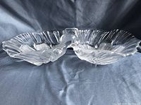 Clear vintage Mikasa crystal oval candy dish showing both compartments and ruffled edges from side angle