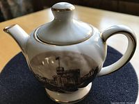 Side view of the miniature teapot showing the Windsor Castle image and gilt detailing.