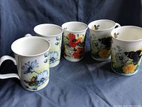 Set of five Roy Kirkham Summer Fields fine china tea mugs with colorful floral and butterfly patterns.