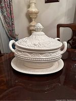 White cream vintage serving bowl with matching lid, plate shown on wooden table