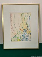 Framed watercolour painting showing the full artwork titled 'Spring Blooms' with a simple gold-tone frame and cream mat.