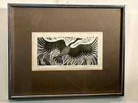 Framed etching showing entire piece, matte and silver frame.