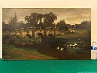 Full view of painting on green background with water bottle for scale