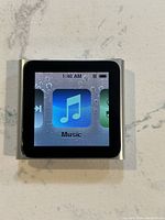 Front view of Apple iPod Nano showing music icon on screen
