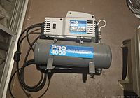 Pro 4000 3/4HP 2 Gallon Oil-Free Air Compressor showing power switch, tank, and label.