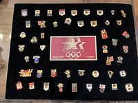 Full set of 48 colored enamel pins and printed display card on black velvet board