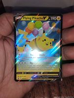 Photo of Flying Pikachu V holographic collector card showing colorful balloons and card stats