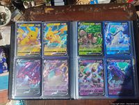 Binder page showing eight full art and V Pokemon cards including Pikachu V, Rilaboom V, Ice Calyrex V and more.