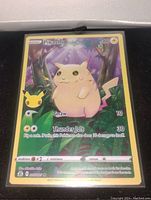Front photo of original base set Pikachu card showing purple ears, full art holo foil, 3 inch size with moves Gnaw and Thunder Jolt
