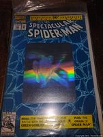 Front cover of The Spectacular Spider-Man comic book with holographic rainbow effect and 30th anniversary details.