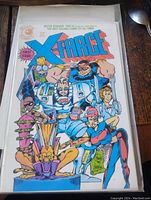 Front cover photo of X-Force vintage comic book first issue showing title, characters, and 'First Issue' badge.