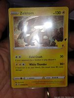 Close up of first Zekrom holographic foil Pokémon card with 130 HP, moves Field Crush and White Thunder, 3 inch size.
