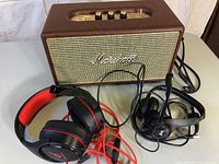 Front view of Marshall speaker with two wired headphones in front
