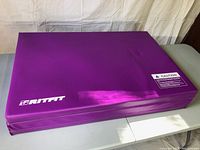 Purple RitFit foldable exercise mat folded into three sections, showing brand logo and caution label.