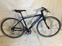 Side profile showing frame, wheels, saddle, and overall condition