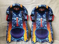 Top view of two blue and orange Aurora foam snow sleds, showing seats and padded handles.