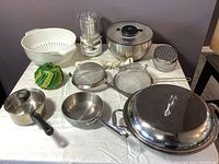 View of the entire lot including cookware, appliances, and kitchen tools on a table.