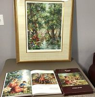 Framed impressionist nature scene print by Eva Makk alongside an open and closed book about the artist and family.