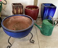Overview showing all four planters, two stands and watering can