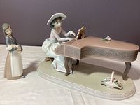 Overview of both figurines: Spring Recital at a piano and Girl with Pig beside it