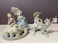 Both Lladró figurines displayed side by side on table