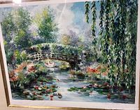 Photo of the print showing a girl crossing under a bridge in canoe with lily pads, showcasing colors, details, and signature.