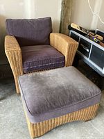 Front view of wicker chair with purple cushions and matching ottoman showing condition and fabric color.
