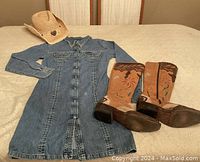 Blue Star rhinestone embellished denim shirt dress laid flat with cowgirl boots and hat beside it