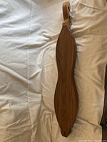 Top view of walnut Appalachian dulcimer showing wood grain and body shape.