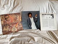 Three LP records displayed with covers: Stevie Wonder 'Characters', Lionel Richie 'Can't Slow Down', Jimmy Smith 'Plain Talk'. Covers show light wear.