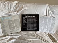 Back covers of the three records showing track lists and credits for Django Reinhardt, Oscar Peterson & Jon Faddis, and Robert Johnson LPs.