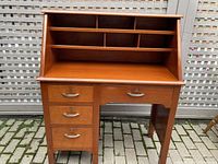 Front view of the solid mahogany desk showing drawers, pigeonholes, and keyholes on drawers.