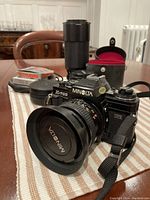 Minolta X-700 body with lens attached and telephoto zoom lens behind