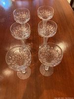 Top-down view of six coupe glasses showing etched bubble motif on bowls