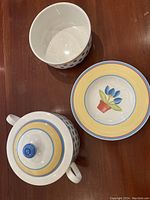 Overhead photo showing inside and lids of serving bowl, soup bowl and vegetable server plate illustrating the pattern and design