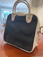 Side view of the blue and white Air Canada vintage bag showing handle and overall shape.